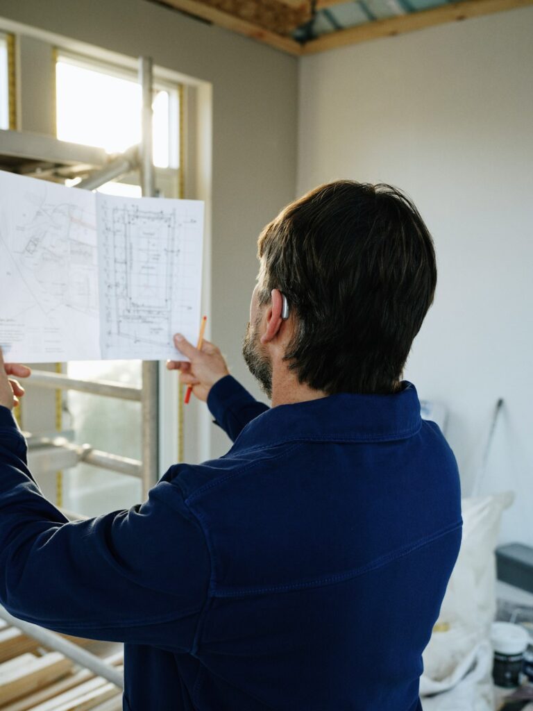 Engineer reviewing building blueprints on a construction site in Nigeria