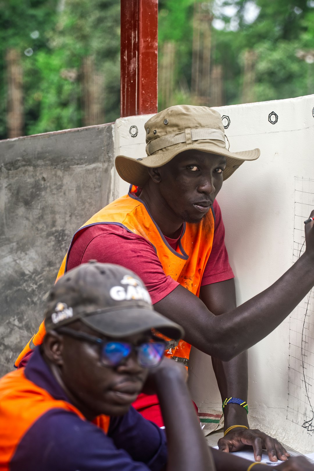 Architect and quantity surveyor reviewing residential building drawings in Nigeria